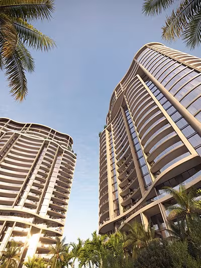 Looking up at the two towers through palm fronds